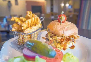  ?? EDDIE MOORE/JOURNAL ?? The smokehouse BBQ burger, with waffle fries, served at The Ranch House.