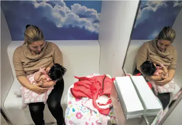  ?? Photos by Gabrielle Lurie / The Chronicle ?? Mavet Coronel feeds her 6-month-old daughter, Allison, in the lactation pod at San Francisco City Hall. A proposal by Supervisor Katy Tang would require workplaces to provide space for pumping milk.