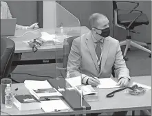  ??  ?? Defendant and former Minneapoli­s police officer Derek Chauvin listens as Hennepin County Judge Peter Cahill presides over pretrial motions before jury selection Tuesday at the Hennepin County Courthouse in Minneapoli­s. Chauvin is charged in the May 25 death of George Floyd. [COURT TV/POOL PHOTO VIA THE ASSOCIATED PRESS]