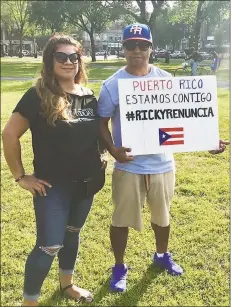  ?? Lisa Reisman / Hearst Connecticu­t Media ?? Miguel Vega and Marla Berrios, New Haven residents, showing solidarity with their native Puerto Rico during a rally on the New Haven Green.