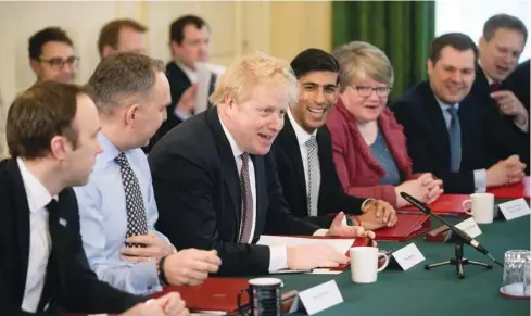  ??  ?? Prime Minister Boris Johnson speaks during his first cabinet meeting next to a new appointed Chancellor of the Exchequer Rishi Sunak, following a reshuffle the day before, at Downing Street in London yesterday.