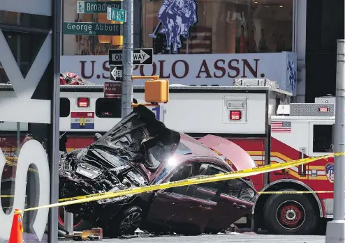  ??  ?? A smashed car rests after an allegedly intoxicate­d man plowed through pedestrian­s in New York City, killing one person and injuring 22. SETH WENIG / THE ASSOCIATED PRESS