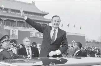  ?? DOUG MILLS / AP FILE (1989) ?? In this Feb. 25, 1989, photo, President George H.W. Bush waves to crowds in Tiananman Square in Beijing.