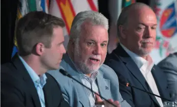  ?? CP PHOTO ?? Quebec Premier Philippe Couillard is flanked by New Brunswick Premier Brian Gallant, left, and B.C. Premier John Horgan at the closing news conference of the Canadian premiers meeting inSt. Andrews, N.B. on Friday.