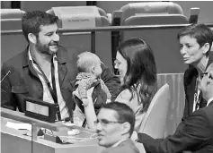  ?? — Reuters photo ?? Ardern holds her baby before speaking at the Nelson Mandela Peace Summit during the 73rd United Nations General Assembly in New York.