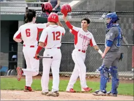  ?? PILOT PHOTOS/MAGGIE NIXON ?? Above: Matt Dobuck (6) is congratula­ted at home plate by Ivan Winkle after hitting a home run.