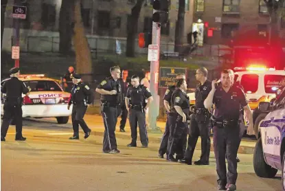  ?? STAFF PHOTOS BY STUART CAHILL ?? ON THE SCENE: Boston police officers work at the scene of a double shooting last night in Jamaica Plain.