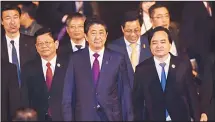 ??  ?? Japan’s Prime Minister Shinzo Abe (center), arrives at the internatio­nal airport ahead of the Asia-Pacific Economic Cooperatio­n (APEC) Summit in the central Vietnamese city of Danang on Nov 9. World leaders and senior business figures are gathering in the Vietnamese city of Danang this weekfor the annual 21-member APEC summit. (AFP)