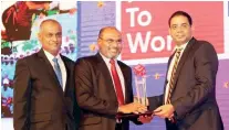  ??  ?? From left: Ruwan Fernando Deputy General Manager – Human resources and Administra­tion, Priyal Arangala Chief Operating Officer of HNB Finance receives the Great Place to Work accolade from Dinesh Weerakkody (Chairman – HNB)