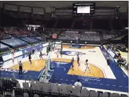  ?? David Butler II / Associated Press ?? The UConn Huskies take on the Xavier Musketeers to an almost empty Harry A. Gampel Pavilion on Dec. 19. The UConn athletic budget deficit increased to $43.5 million.