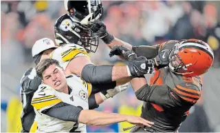  ?? THE ASSOCIATED PRESS FILE PHOTO ?? Pittsburgh Steelers quarterbac­k Mason Rudolph, left, winces as Browns defensive end Myles Garrett hits him with his helmet at the end of Thursday night’s game in Cleveland.