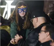  ?? ?? Rosie Lipsker, 12, hands out latkes while wearing novelty light up menorah glasses. During the Magical Chanukah event, with magician Joshua Jay, at Chabad-Lubavitch of Berks County Wednesday evening, Dec. 1.