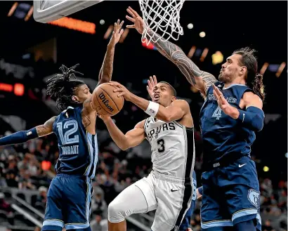  ?? AP ?? Memphis Grizzlies’ Steven Adams, right and Jo Morant put pressure on San Antonio Spurs’ Keldon Johnson as he goes to the basket during yesterday’s NBA game in San Antonio.