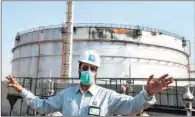  ?? (AFP) ?? An employee at the Saudi Aramco gestures while standing near a damaged silo, at the plant in Jeddah on Tuesday.