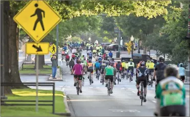  ?? Steven Eckhoff / RN-T ?? Riders make their way down Broad Street at the start of this year’s Up the Creek event early Saturday morning. From downtown, riders would make their way out on Old Dalton Road and split off onto various courses before returning back to the Town Green.