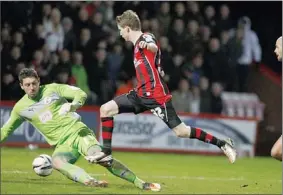  ??  ?? AFTER YOU: Bournemout­h’s Eunan O’Kane makes it 3-0