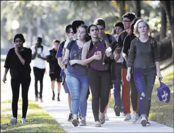  ?? Wilfredo Lee The Associated Press ?? Fleeing students leave Marjory Stoneman Douglas High School in Parkland, Fla., on Feb. 14. Descriptio­ns of the massacre that students and teachers gave authoritie­s have been made public.