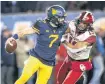  ?? [PHOTO BY IAN MAULE, TULSA WORLD] ?? Curtis Bolton tries to tackle West Virginia quarterbac­k Will Grier during OU’s 59-56 win on Nov. 23.