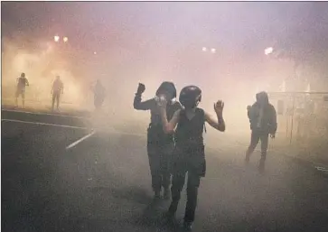  ?? Beth Nakamura Associated Press ?? FEDERAL OFFICERS fired tear gas and less-lethal rounds at a demonstrat­ion Thursday in Portland, Ore., just hours after the head of the Department of Homeland Security called the protesters “violent anarchists.”