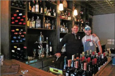  ?? KRISTI GARABRANDT — THE NEWS-HERALD ?? Co-owners Chad Bloom and Hunter Toth prepare for the April 26 grand opening of The Hook and Hoof in Downtown Willoughby.