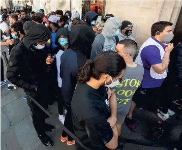  ??  ?? People queue outside Nike Town at Oxford Circus, London, as non-essential shops in England reopened their doors