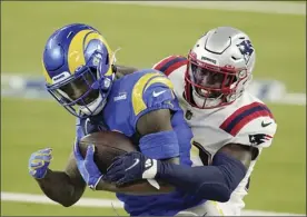  ?? AP photo ?? Rams running back Cam Akers is tackled by Patriots defensive back Devin McCourty during the first half of Los Angeles’ 24-3 win over New England on Thursday.