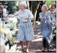  ?? AP/TOM O’NEAL ?? Nancy “Grongong” Rutchik (left) and Flossie “Grammy” Pack, walk down the aisle as flower girls for the wedding of their granddaugh­ter Lucy Schanzer in Carmel, Calif., in 2015. Lucy married Kyle Schanzer.