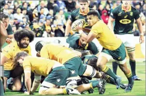  ?? GREG WOOD/AFP ?? Australia’s Will Genia runs with the ball during the Rugby Championsh­ip match with South Africa in Perth on Saturday.