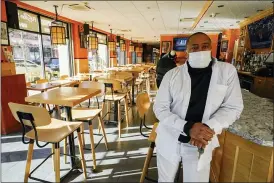  ?? MARY ALTAFFER — THE ASSOCIATED PRESS ?? Andrew Walcott at his Fusion East Caribbean & Soul Food restaurant in Brooklyn, New York. Walcott had to furlough four employees at his restaurant just before Christmas, after New York state stopped allowing indoor dining.