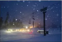  ?? CHRISTIAN PONDELLA/MAMMOTH MOUNTAIN SKI AREA VIA AP ?? Snow falls around a lodge and ski lifts in Mammoth Lakes on Jan. 22. Since early this month, snowpack jumped from 25% of normal to 52%.