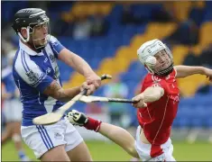  ??  ?? Eire Og’s Anthony Byrne gets his shot away despite the efforts of Glenealy’s Ruairi O’Neill. Photos: Garry O’Neill