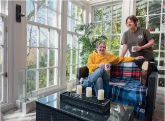  ??  ?? Clockwise from topleft: Kim brought the tapestries from her London home; a gothic arch frames the shower cubicle in the laird’s bathroom; Kim and Maria enjoying downtime; a claw foot bath adds glamour under the vaulted ceilings.