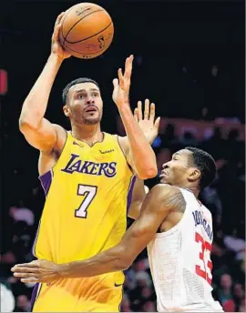  ?? Harry How Getty Images ?? “I JUST WANT to be on the court and make a difference,” says the Lakers’ Larry Nance Jr., shown launching a shot against the Clippers on Friday.