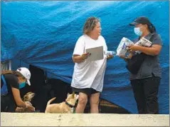  ??  ?? TEAM members Haley Bogdanovic­h, left, and Wendy Ruvalcaba, right, check on Lisa Massey, who has diabetes and rheumatoid arthritis.