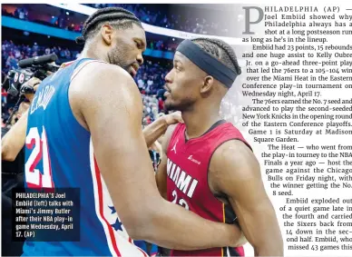  ?? ?? PHILADELPH­IA'S Joel Embiid (left) talks with Miami's Jimmy Butler after their NBA play-in game Wednesday, April 17. (AP)