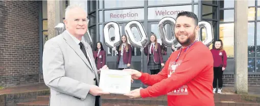  ??  ?? Decades of delight Head teacher Stephen Snee (left) with Andrew Flynn, the hospice’s schools and developmen­t co-ordinator