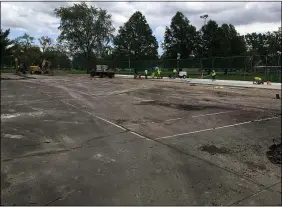  ?? RICHARD PAYERCHIN — THE MORNING JOURNAL ?? Lorain Public Property Department workers smooth out concrete and build forms for the new tennis and pickleball courts Oct. 12at South Lakeview Park. Lorain city officials hope voters will say yes to a five-year, 1.5-mill levy that would raise about $1.33million a year for staff, equipment and programs at Lorain’s green spaces.