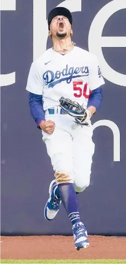  ?? TONYGUTIER­REZ/AP ?? Dodgers right fielder Mookie Betts celebrates after robbing Atlanta Braves’ Marcell Ozuna of a home during the fifth inning in Game 6 Saturday in Arlington, Texas.