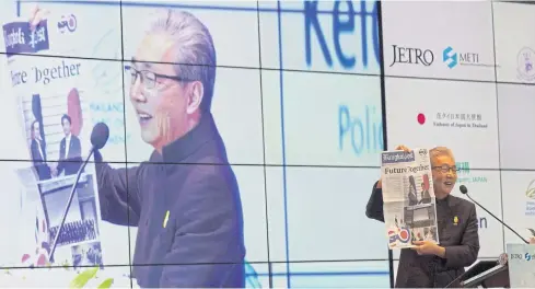  ?? PHOTOS BY PAWAT LAOPAISARN­TAKSIN ?? Deputy Prime Minister Somkid Jatusripit­ak displays the front page of a special publicatio­n of the ‘Bangkok Post’ at a symposium on Thailand 4.0 held at Bangkok Marriott Marquis Queen’s Park yesterday. The audience included 570 investors from Japan, on...