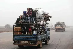  ?? Ghaith al-Sayed / Associated Press ?? Civilians ride in a truck Monday as they flee Maaret al-Numan, Syria, ahead of a government offensive. The Syrian airstrikes have pushed up to 100,000 people from their homes as President Bashar Assad retakes territory from rebels.