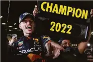  ?? Toru Hanai / Associated Press ?? Red Bull driver Max Verstappen celebrates with teammates as he became F1 drivers’ world champion, following the Japanese Formula One Grand Prix at the Suzuka Circuit in Suzuka, Japan, on Sunday.