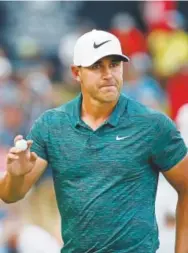  ?? Jeff Roberson, The Associated Press ?? Brooks Koepka waves to the crowd after making his birdie putt on the 15th green Sunday during the PGA Championsh­ip.