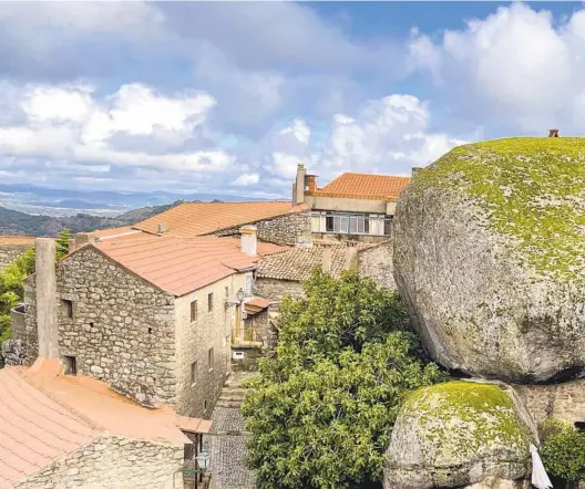  ?? KRISTEN DE GROOT PHOTOS VIA AP ?? Stonework abounds on and around the homes nestled in with the mountainsi­de’s massive boulders in the village of Monsanto.