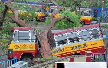  ?? — PTI ?? Mangled remains of a bus after a tree fell on it during Cyclone Amphan, in Kolkata on Thursday.