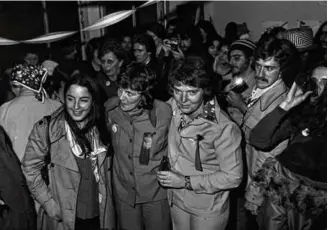  ?? BONNIE UNSWORTH/THE HISTORY PROJECT ?? Elaine Noble (center) on the night of her election to the Massachuse­tts House in 1974. Noble will be one of the edit-a-thon subjects.