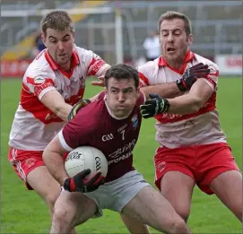  ??  ?? Paudie Kelly of St. Martin’s under pressure from Dean O’Toole and Denis Jones.