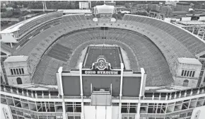  ?? DORAL CHENOWETH/COLUMBUS DISPATCH ?? Ohio Stadium has had several additions and renovation­s, including permanent south stands and the scoreboard that rises behind them.