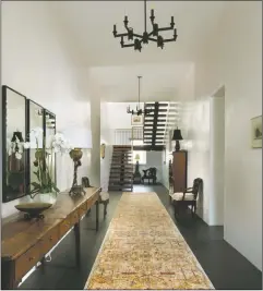  ??  ?? Above, art and antiques showcased in a simple serene setting in the rebuilt and refurnishe­d Francisca Hinojos House
Right, the rhythm of the stair treads adds visual interest to this grand entry hall