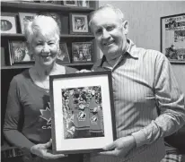  ?? JEREMY FRASER • SaltWire Network ?? Matt and Kay Batherson hold a picture of their grandson Drake Batherson following his gold medal victory at the 2018 IIHF World Junior Hockey Championsh­ip in Buffalo, N.Y. The North Sydney couple was devastated to learn Batherson wouldn't be able to play in the 2022 NHL All-Star game due to an injury.