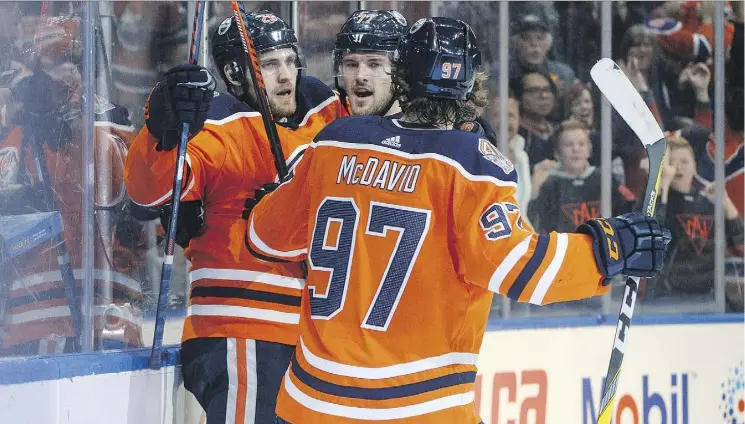  ?? JASON FRANSON/CANADIAN PRESS ?? Leon Draisaitl, Oscar Klefbom and Connor McDavid celebrate Klefbom’s winning goal against Dallas in OT Tuesday. It was Klefbom’s first goal of the season.